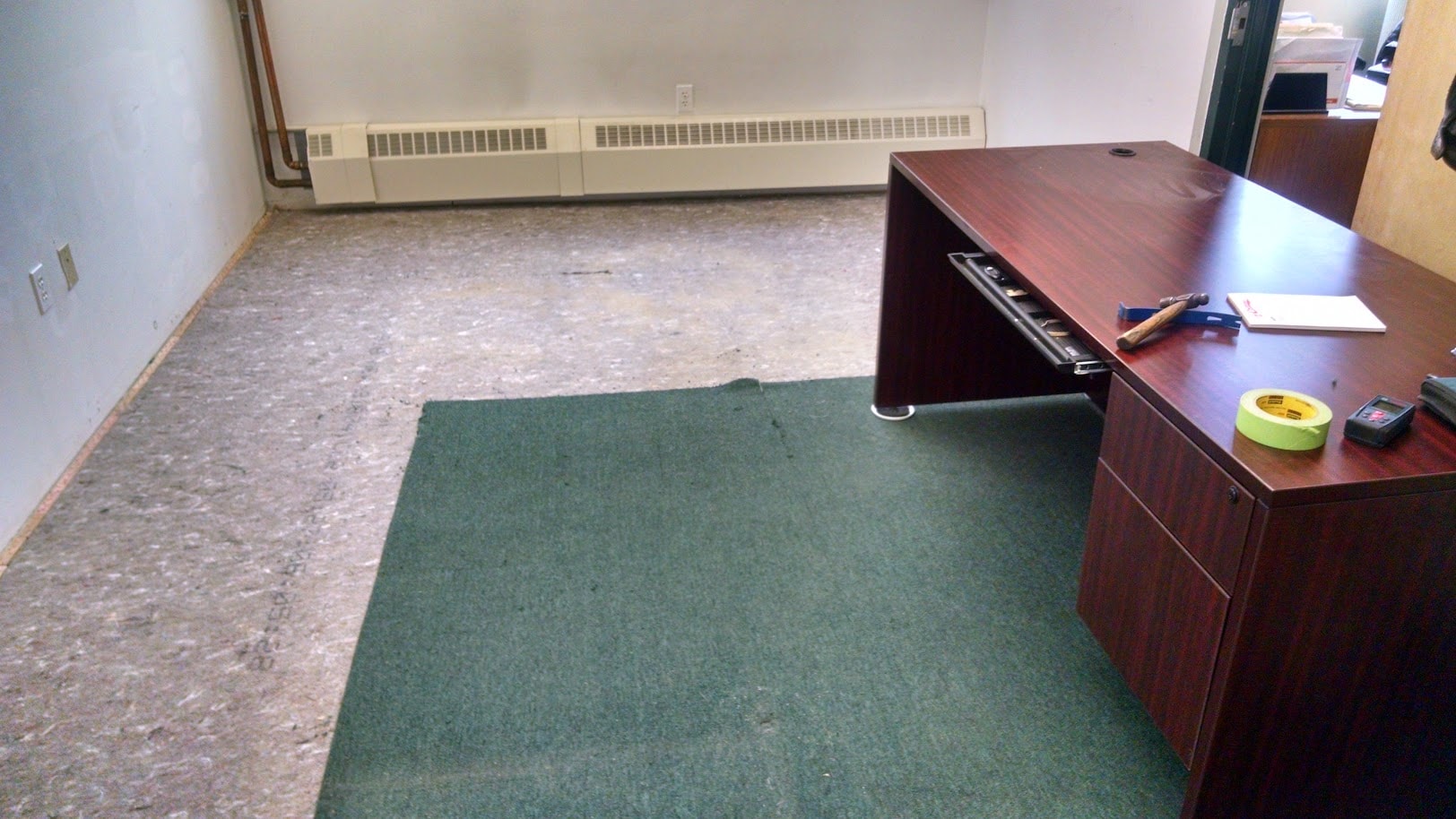 Penn Hills office floor — carpet fully removed, subfloor exposed